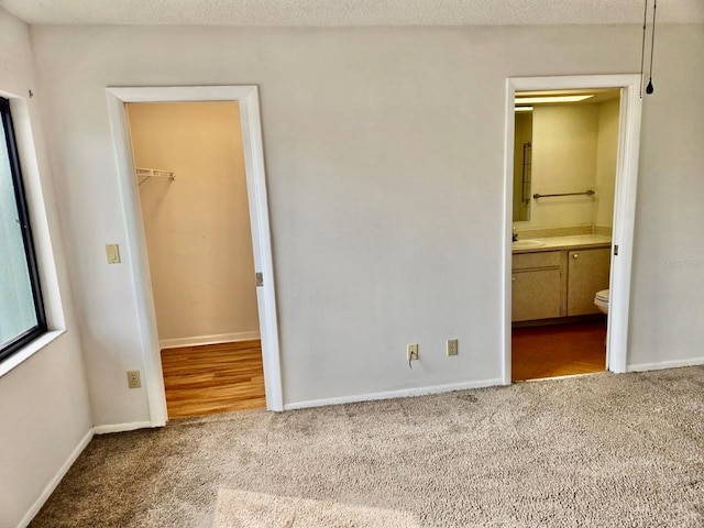 5 Buck Cir # B5, Haines City, FL 33844 - unfurnished bedroom featuring a closet, carpet, baseboards, a sink, and a spacious closet