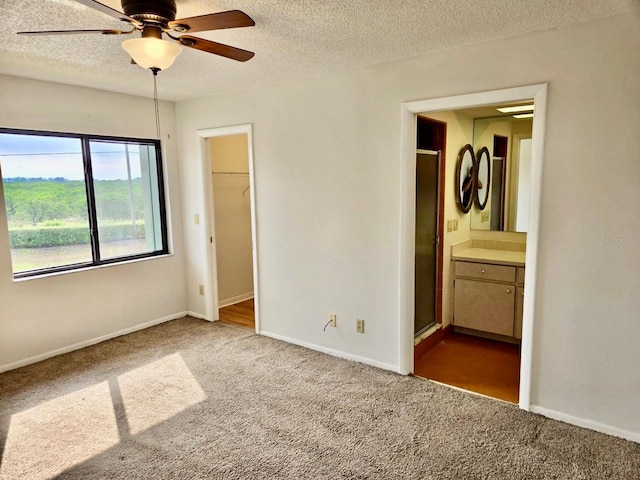 5 Buck Cir # B5, Haines City, FL 33844 - unfurnished bedroom featuring a textured ceiling, connected bathroom, and carpet floors
