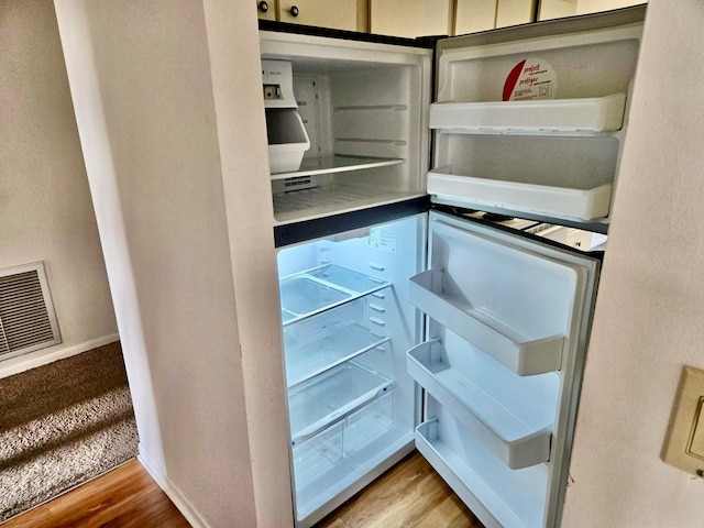 5 Buck Cir # B5, Haines City, FL 33844 - interior details featuring refrigerator, baseboards, visible vents, and wood finished floors