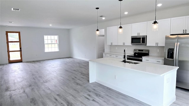 699 Marion Oaks Trl, Ocala, FL 34473 - kitchen featuring visible vents, light countertops, appliances with stainless steel finishes, and light wood-style floors