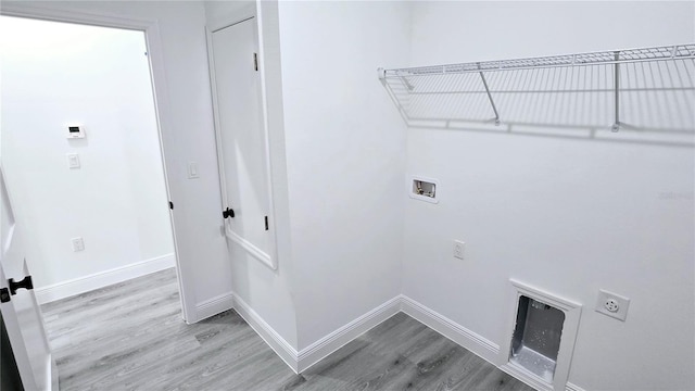699 Marion Oaks Trl, Ocala, FL 34473 - washroom with laundry area, hookup for a washing machine, wood finished floors, hookup for an electric dryer, and baseboards