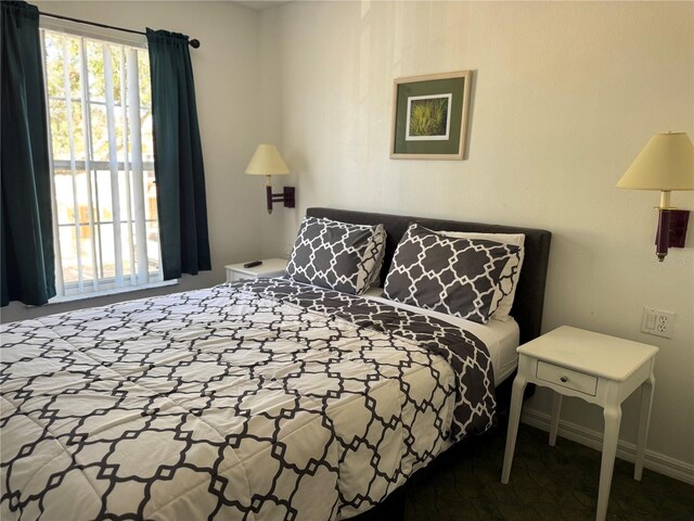 1119 Park Ridge Cir, Kissimmee, FL 34746 - bedroom with baseboards and multiple windows