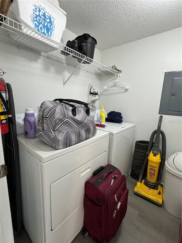 1119 Park Ridge Cir, Kissimmee, FL 34746 - clothes washing area with electric panel, washer and clothes dryer, wood finished floors, a textured ceiling, and laundry area