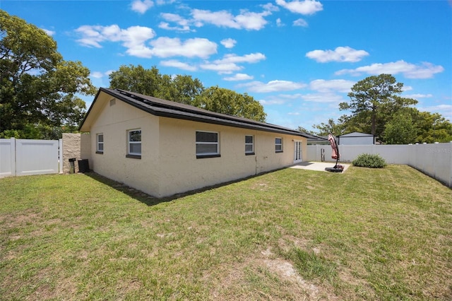 725 Laurel Way, Casselberry, FL 32707 - rear view of property featuring a fenced backyard, solar panels, stucco siding, and a patio area