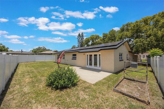 725 Laurel Way, Casselberry, FL 32707 - rear view of house with french doors, solar panels, stucco siding, a patio, and a fenced backyard