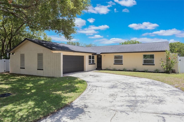 725 Laurel Way, Casselberry, FL 32707 - ranch-style home featuring a garage and asphalt driveway