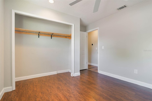 725 Laurel Way, Casselberry, FL 32707 - unfurnished bedroom with a closet, wood finished floors, a ceiling fan, and a textured ceiling