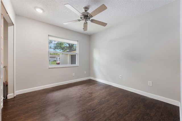 725 Laurel Way, Casselberry, FL 32707 - unfurnished bedroom featuring dark wood-style flooring, a textured ceiling, and ceiling fan