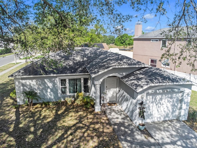 single story home with a chimney, a shingled roof, concrete driveway, stucco siding, and a garage