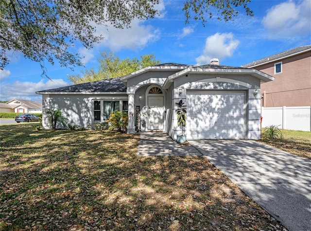single story home with an attached garage, concrete driveway, fence, and stucco siding