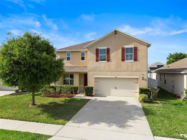 traditional-style home with concrete driveway, an attached garage, stucco siding, and a front lawn