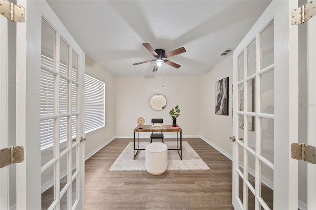 office with french doors, wood finished floors, and visible vents