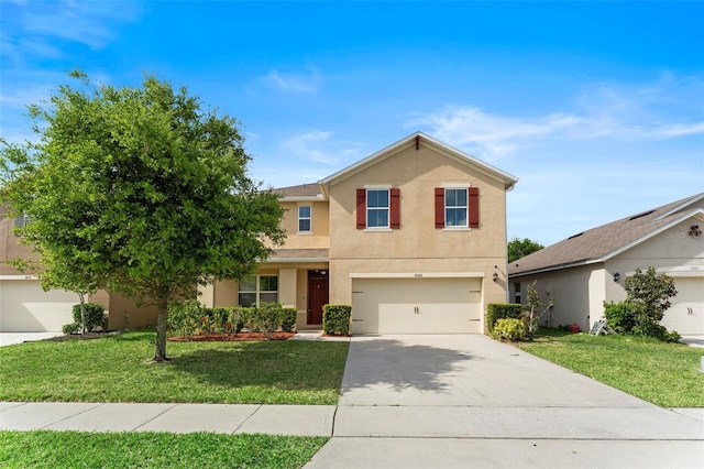 traditional-style house with a front lawn, an attached garage, driveway, and stucco siding