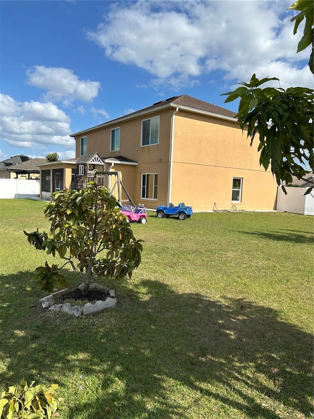 5406 Crepe Myrtle Cir, Kissimmee, FL 34758 - back of house featuring a lawn and stucco siding