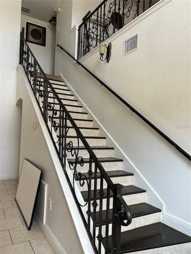5406 Crepe Myrtle Cir, Kissimmee, FL 34758 - staircase with baseboards, tile patterned flooring, and visible vents