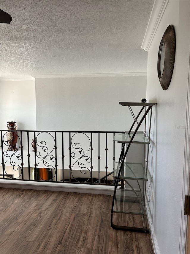 5406 Crepe Myrtle Cir, Kissimmee, FL 34758 - stairway with ornamental molding, a textured ceiling, and wood finished floors