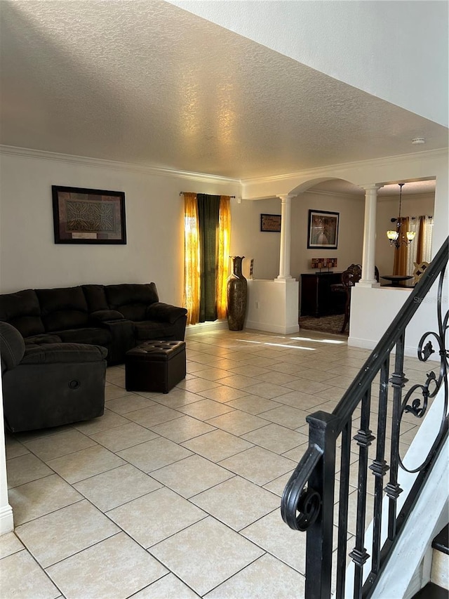 5406 Crepe Myrtle Cir, Kissimmee, FL 34758 - living room with a textured ceiling, decorative columns, light tile patterned flooring, and ornamental molding