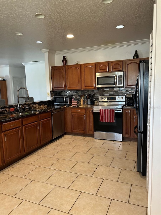 5406 Crepe Myrtle Cir, Kissimmee, FL 34758 - kitchen with tasteful backsplash, ornamental molding, stainless steel appliances, and a textured ceiling