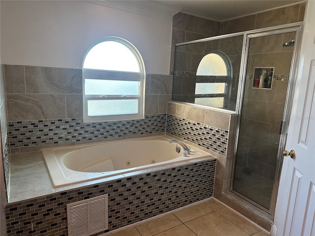 5406 Crepe Myrtle Cir, Kissimmee, FL 34758 - full bath with visible vents, a jetted tub, tile patterned flooring, and a shower stall