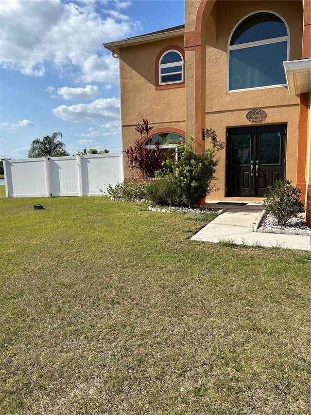 5406 Crepe Myrtle Cir, Kissimmee, FL 34758 - view of yard featuring fence and french doors