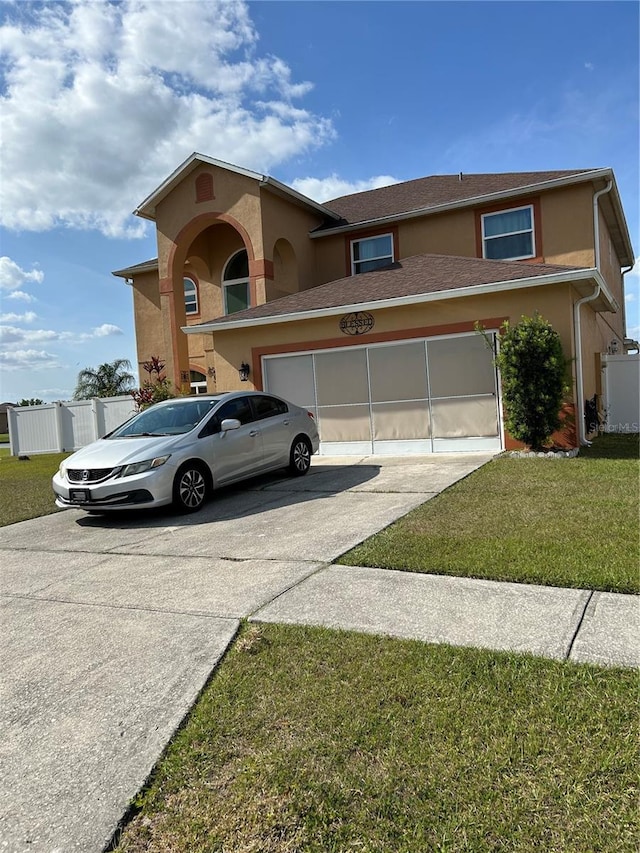 5406 Crepe Myrtle Cir, Kissimmee, FL 34758 - view of front of home featuring stucco siding, fence, a front yard, and concrete driveway