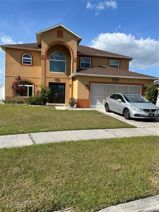 5406 Crepe Myrtle Cir, Kissimmee, FL 34758 - view of front of property featuring an attached garage, a front lawn, and stucco siding