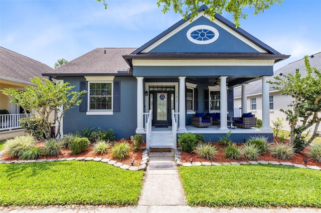 13034 Royal Fern Dr, Orlando, FL 32828 - view of front of home with a front yard, a porch, stucco siding, and a shingled roof