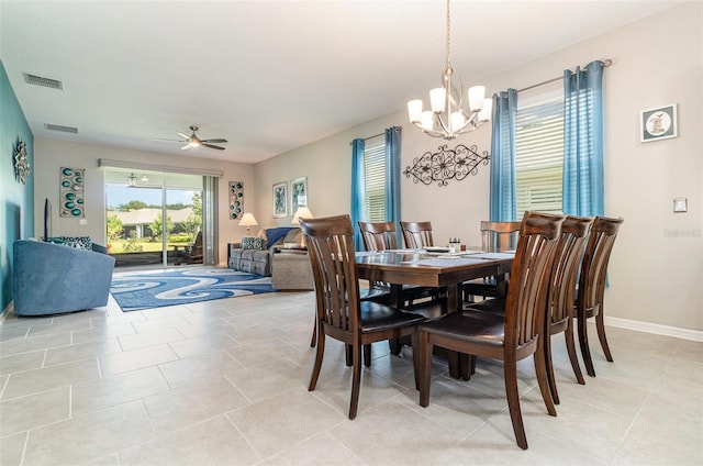 dining space featuring visible vents, light tile patterned floors, and ceiling fan with notable chandelier
