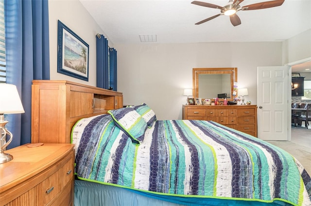 carpeted bedroom with visible vents and ceiling fan