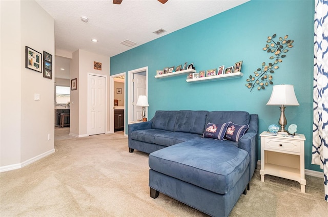 carpeted living room featuring baseboards, a ceiling fan, visible vents, and recessed lighting