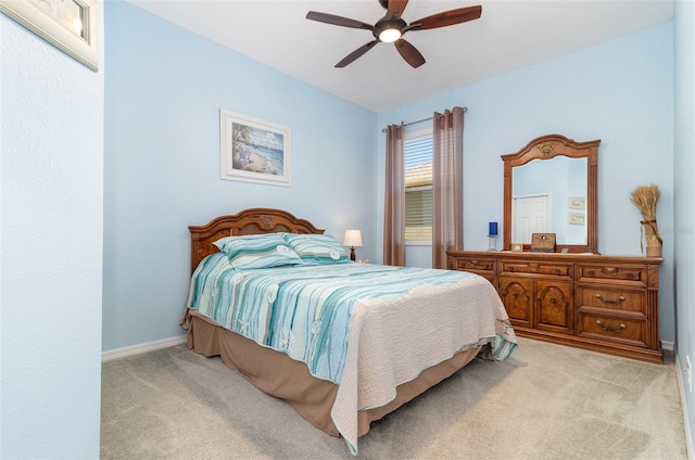 bedroom featuring a ceiling fan, baseboards, and light carpet