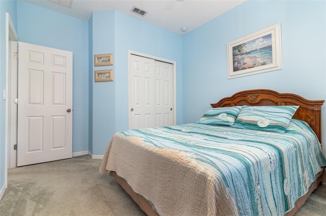 carpeted bedroom with baseboards, visible vents, and a closet