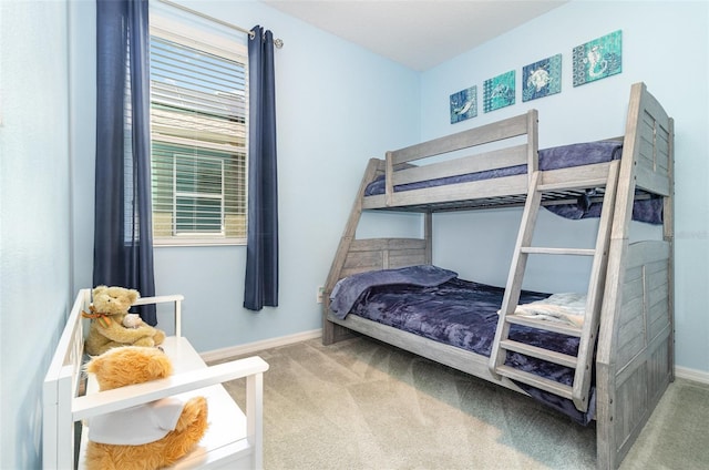 bedroom featuring carpet floors and baseboards