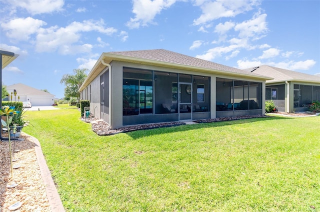 back of property with a yard and a sunroom