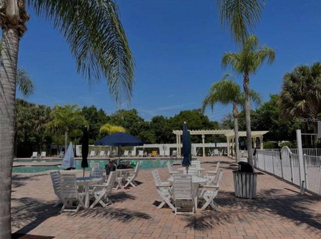 pool featuring fence and a patio
