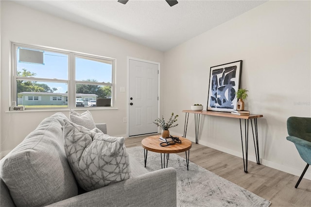 101 W Wallace St, Orlando, FL 32809 - living room featuring baseboards, a textured ceiling, ceiling fan, and light wood finished floors