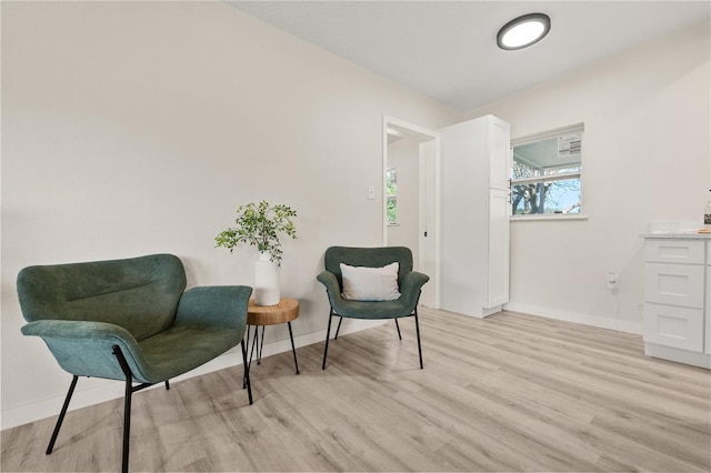101 W Wallace St, Orlando, FL 32809 - sitting room with baseboards and light wood-style floors
