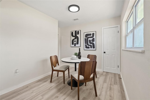 101 W Wallace St, Orlando, FL 32809 - dining area featuring baseboards, visible vents, and light wood-style floors