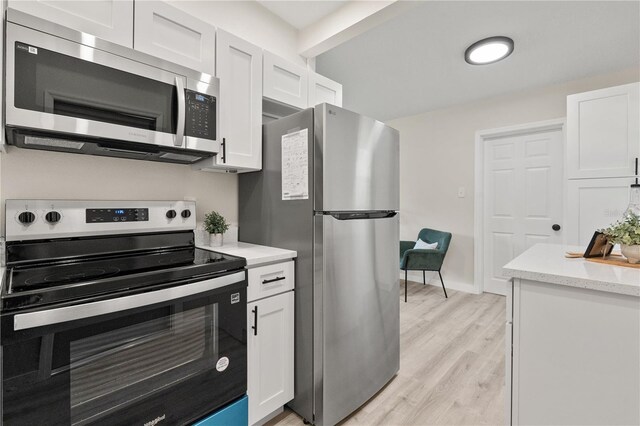 101 W Wallace St, Orlando, FL 32809 - kitchen featuring light stone counters, light wood finished floors, stainless steel appliances, baseboards, and white cabinets