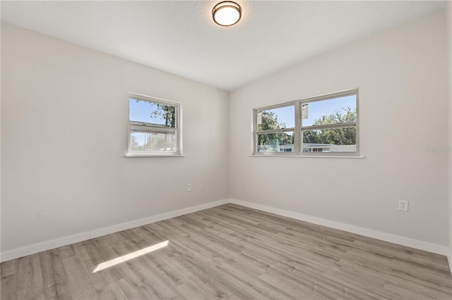 101 W Wallace St, Orlando, FL 32809 - unfurnished room featuring plenty of natural light, baseboards, and wood finished floors