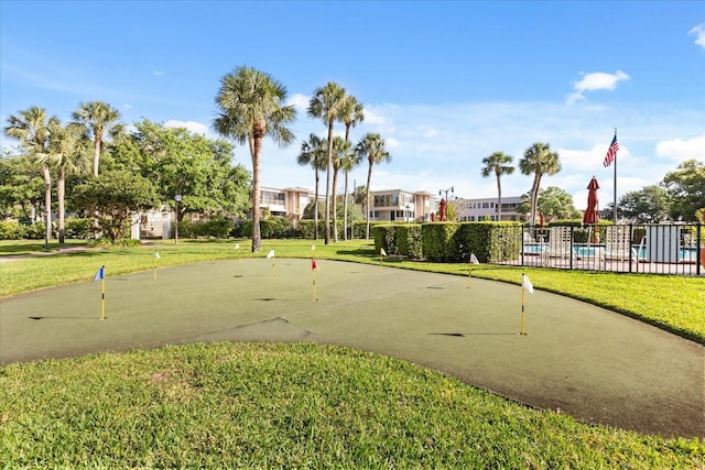 surrounding community featuring a pool, a yard, and fence