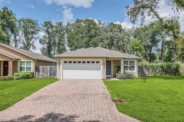 559 E Magnolia Ave, Longwood, FL 32750 - single story home featuring a front yard, stucco siding, an attached garage, fence, and decorative driveway
