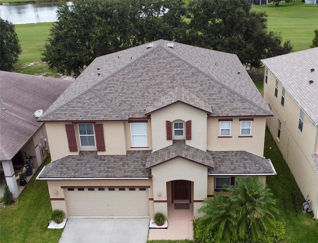 422 Janice Kay Pl, Kissimmee, FL 34744 - view of front facade featuring stucco siding, concrete driveway, and a shingled roof
