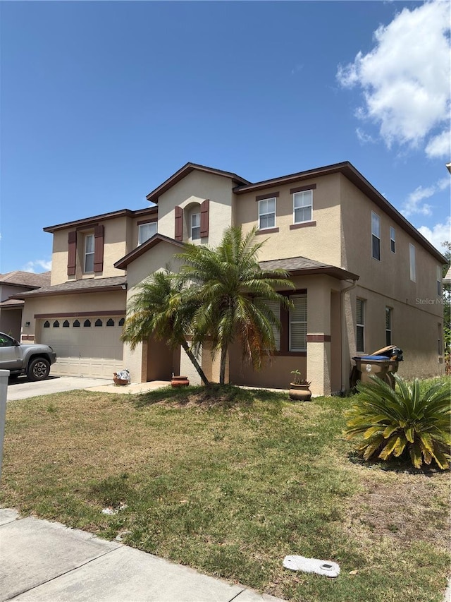 422 Janice Kay Pl, Kissimmee, FL 34744 - traditional home with an attached garage, a front lawn, stucco siding, and driveway