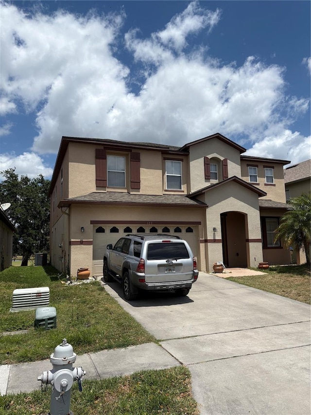 422 Janice Kay Pl, Kissimmee, FL 34744 - view of front of property featuring an attached garage, driveway, a front yard, and stucco siding