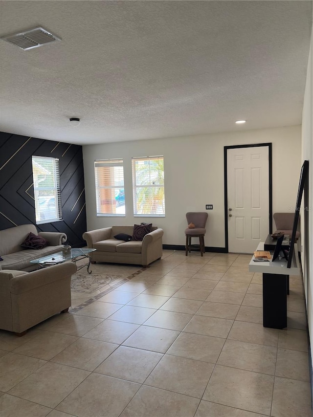 422 Janice Kay Pl, Kissimmee, FL 34744 - living area with baseboards, visible vents, a textured ceiling, and light tile patterned flooring