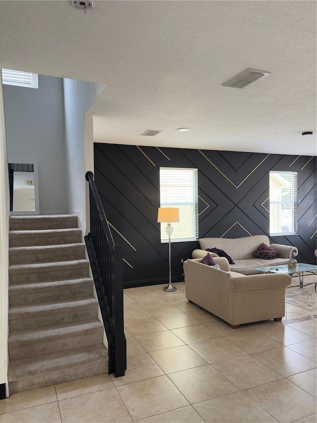 422 Janice Kay Pl, Kissimmee, FL 34744 - living area with light tile patterned floors, visible vents, a textured ceiling, and stairway