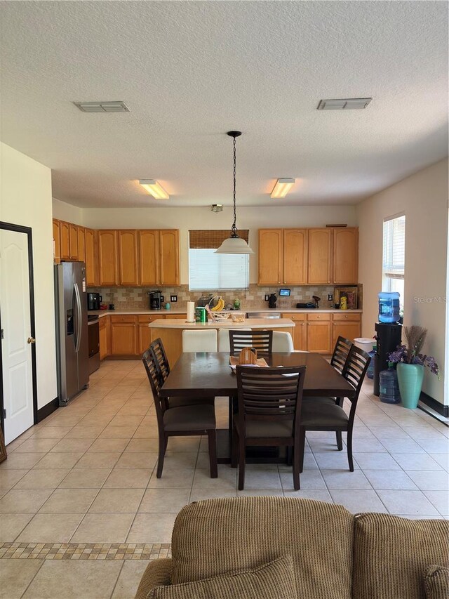 422 Janice Kay Pl, Kissimmee, FL 34744 - dining room with light tile patterned flooring, a textured ceiling, and visible vents