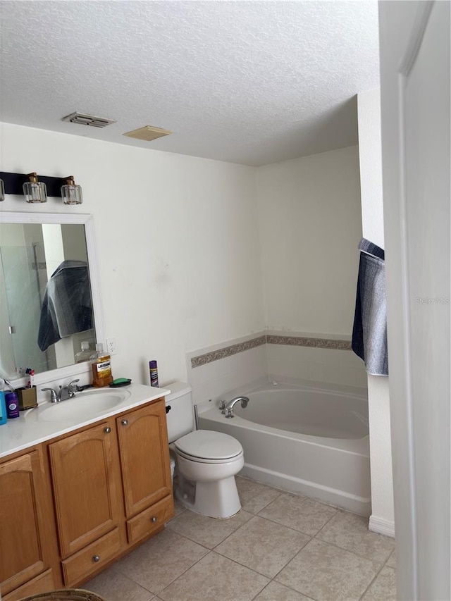 422 Janice Kay Pl, Kissimmee, FL 34744 - bathroom featuring tile patterned floors, visible vents, toilet, a bath, and a textured ceiling