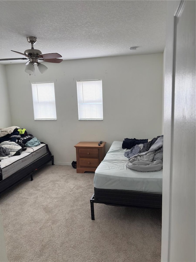 422 Janice Kay Pl, Kissimmee, FL 34744 - bedroom featuring a ceiling fan, carpet flooring, multiple windows, and a textured ceiling